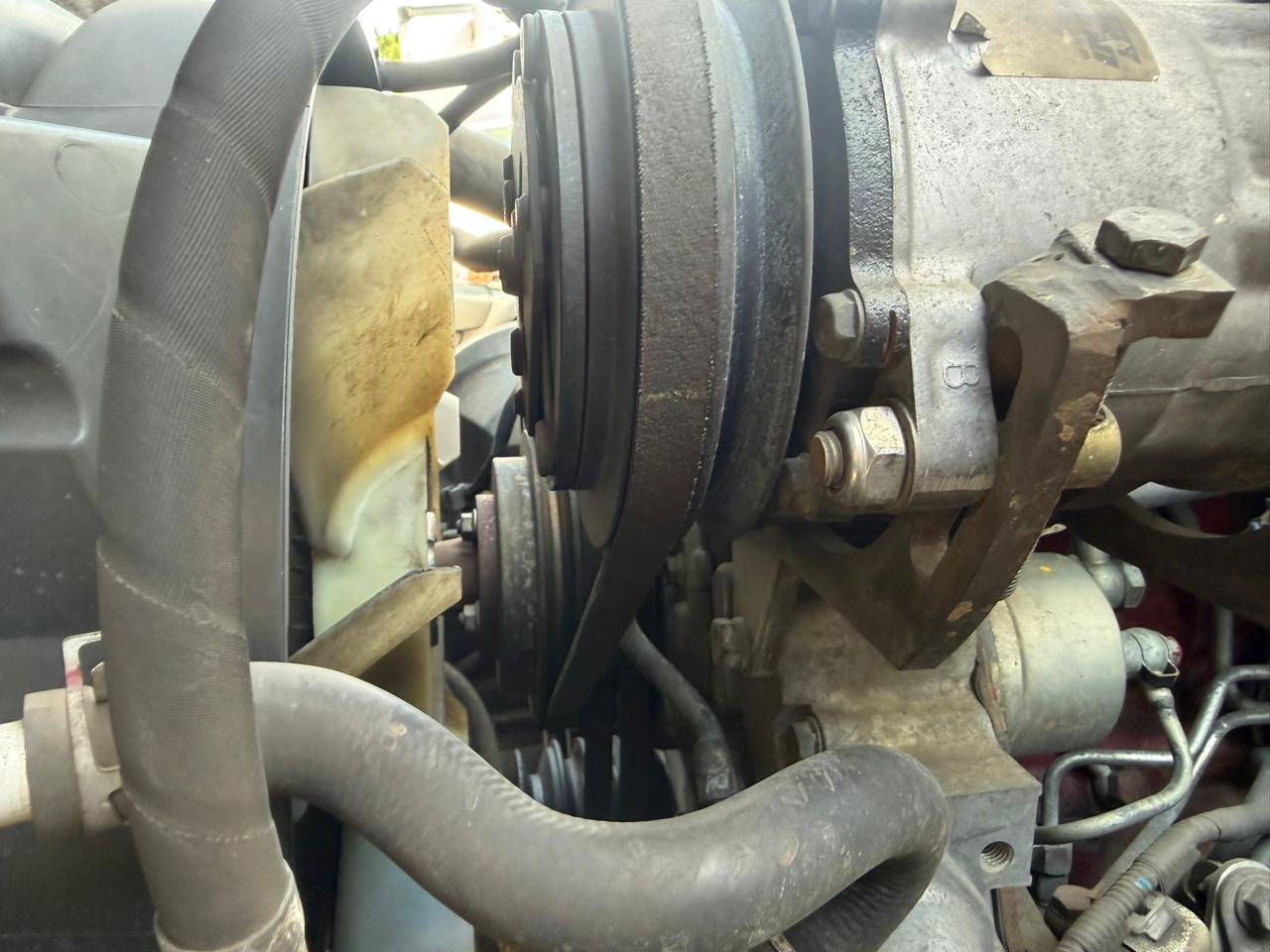 Fan belts tight and show no obvious damage